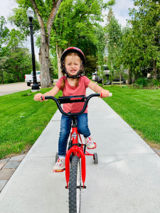 photo-of-young-girl-riding-bike-by-sidewalk-2537101 copy